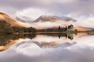 Kilchurn Castle, sunrise, early morning mist and light, a ruin on a rocky peninsula, the northeastern end of Loch Awe, in Argyll and Bute, Scotland, UK. March 2017