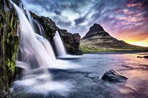 Cool coloured wilderness Collection: Kirkjufellsfoss waterfall at sunrise, with Kirkjufell mountain in the background