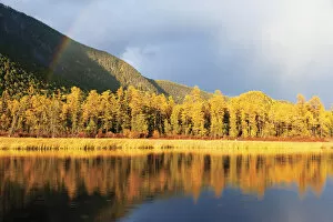 Lake Baikal landscape in autumn, trees reflected in water. Zabaikalsky National Park