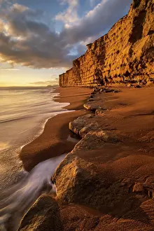 Sandstone Prints: Late evening light bathing the sandstone cliffs at Burton Bradstock
