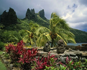 Lush vegetation and traditional statues in the Marquesas Islands, French Polynesia