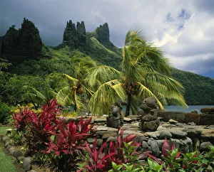 Lush vegetation and traditional statues in the Marquesas Islands, French Polynesia