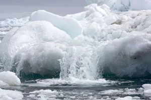Climate Change Prints: Meltwater flowing off an iceberg. Near Yalour Islands, Wilhelm Archipelago, Antarctica