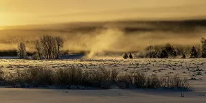 Images Dated 4th November 2022: Mist rises from the Snake River on a cold January morning in Grand Teton National Park, Wyoming, USA