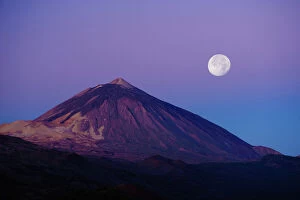 Full moon over Teide volcano (3, 718m) at sunrise, Teide National Park, Tenerife, Canary Islands