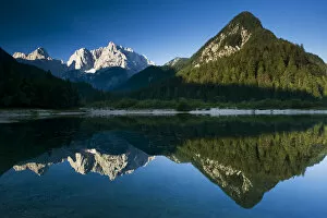 Mount Prisojnik (2, 547m) and Mount Razor (2, 601m) with reflection in a lake beside