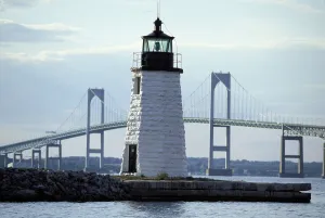 Coasts Prints: The Newport Harbor Light (Goat Island Light) standing framed by the giant Newport Bridge