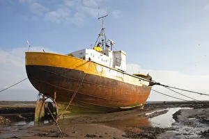 Skies Prints: Old fishing boat held upright at low tide with ropes and chains, Roa Island, Morecambe Bay