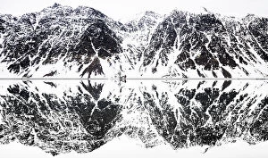 Best of 2022 Collection: Perfectly mirrored landscape of snow covered mountains along the fjords in Svalbard