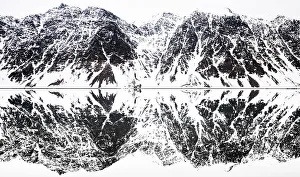 Svalbard Prints: Perfectly mirrored landscape of snow covered mountains along the fjords in Svalbard