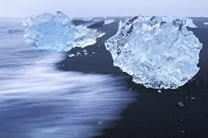 Pieces of iceberg calved from Vatnajokull glacier on black sand beach, Iceland 2005