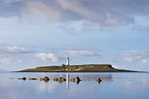 Pladda Lighthouse, with Seals (Phoca vitulina) on rocks in foreground at Seal Shore Campsite