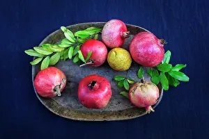 Myrtales Prints: Pomegranates (Punica granatum) and a Lemon on a plate