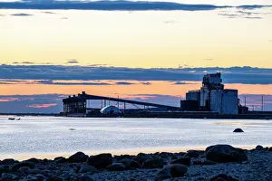 Sunset Prints: The port of Churchill backlit at sunset viewed from the shores of the Churchill River