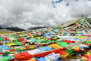 Traditional Prints: Prayer flags on shores of Nam-Tso Lake. Tibet, China