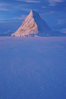 Images Dated 25th October 2011: Pyramid of sea ice catching the first rays of the returning sun in the high Arctic