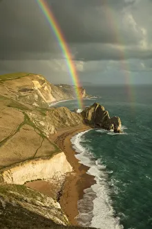 Rainbows Prints: Rainbow over Durdle Door and the Jurassic Coast, Dorset, England, UK. October 2019