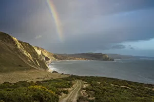 Spectrum Collection: Rainbow over Mupe Bay on Christmas Eve, Jurassic Coast, Dorset, England, UK