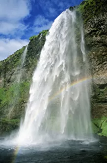 Rainbow in spray of Seljalandsfoss waterfall, Iceland