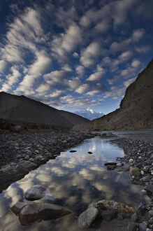 Reflection of clouds in water next to the Kali Ghandaki river, Nilgiri range, Chhusang