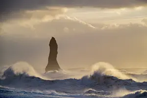 Wave Prints: Reynisdrangar sea stack with large waves crashing onto the black sand beach