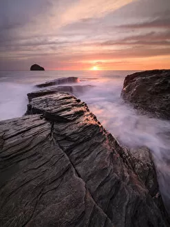 RF - High tide amongst rocks on Trebarwith Strand, at sunset. North Cornwall, England, UK