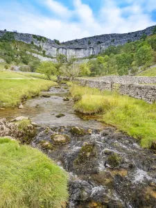River at base of limestone pavement. Malham Cove, Yorkshire Dales National Park, England River at base of limestone pavement. Malham Cove, Yorkshire Dales National Park, England