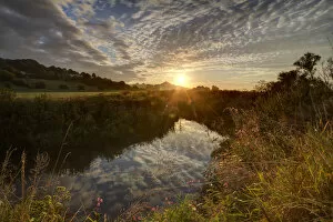 River Brue, at sunrise with Glastonbury Tor in background, Somerset, UK, August
