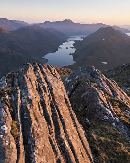 Rock formations on Bhudhie Bheinn lit by the setting sun. Knoydart, Scotland, UK