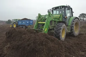 RSPB reserves staff scraping heath surface layer and litter at Dunwich Heath National Trust reserve