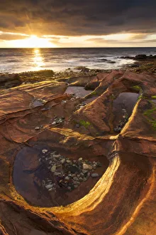 Stones Prints: Sandstone rocks at sunrise, Corrie, Isle of Arran, Scotland, UK, October 2013