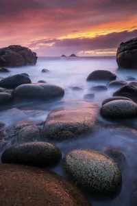 Sea and stones at Porth Nanven beach, with rising tide at sunset, The Cot Valley Sea and stones at Porth Nanven beach, with rising tide at sunset, The Cot Valley