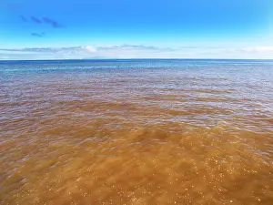 Pollution Prints: Sewage pollution flowing out from a river into the sea