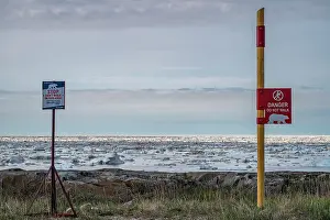 Canada Prints: Signs posts warning tourists of polar bears near the seafront