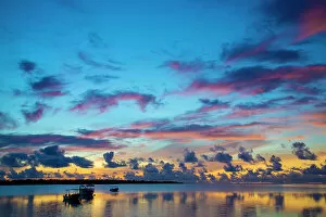 Pink Gallery: The sky lights up at dawn with boats floating on still waters off the island of Yap, Micronesia