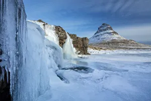 Snow covered Kirkjufell Mountain and frozen waterfalls, , Snaefellsness Peninsula
