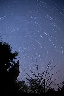 Long Exposure Prints: Star trails at night over silhouetted dovecote and trees