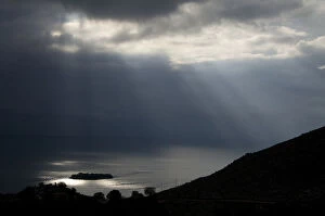 Sun shining through clouds over Lake Skadar near Murici, Lake Skadar National Park