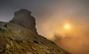 Sunlight shining through clouds on Slieve Bernagh North Tor, Mourne Mountains