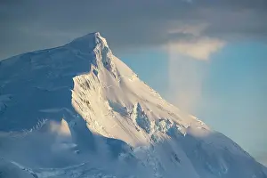 Summit Prints: Sunrise over snow-covered mountain peak