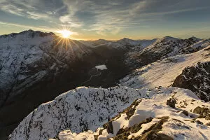 Images Dated 4th July 2017: Sunset over snow covered mountains, view north west along Aonach Eagach ridge towards Glen Coe