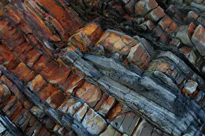 Sandstone Prints: Tilted sandstone, mudstone and siltstone rock strata contorted by tectonic plate movement during Hercynian orogeny