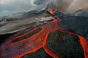 Rock Gallery: Tolbachik Volcano erupting with lava flowing down the mountain side. Kamchatka, Russia