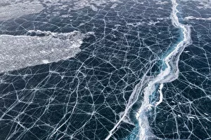Aerial View Gallery: Transparent black ice with cracks on Lake Baikal, aerial shot