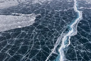 Aerial View Gallery: Transparent black ice with cracks on Lake Baikal, aerial shot