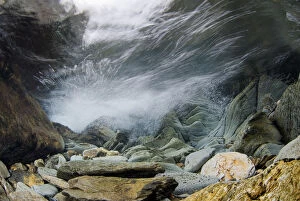 Underwater landscape within a mountain stream, showing water turbulence, Snowdonia NP