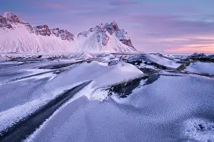 Sand Dune Prints: Vestrahorn mountain and sand dunes covered in snow at sunrise