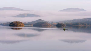 Images Dated 15th September 2017: View over Derwentwater, towards Friars Crag in autumn colour and morning mist with lone rower
