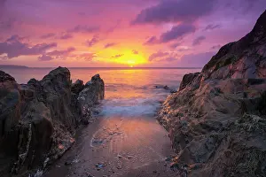 Devon Prints: View looking out to sea at sunrise from beach at Tor cross