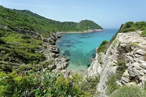 Mediterranean Prints: View of Porto Timoni Bay, fringed by dense maquis scrubland, Corfu, Greece. May, 2024